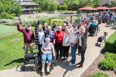 A group of residents and team members are pictured together in the Winston Park courtyard.
