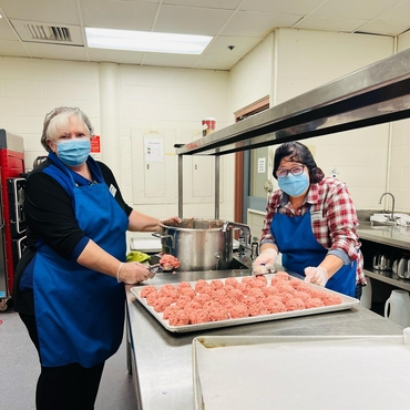 Pauline and Lina prepare meatballs at Humber Heights, helping raise funds to support Ukrainians coming to Canada.