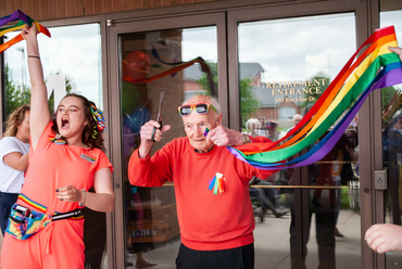 Cutting the pride ribbon into The Village