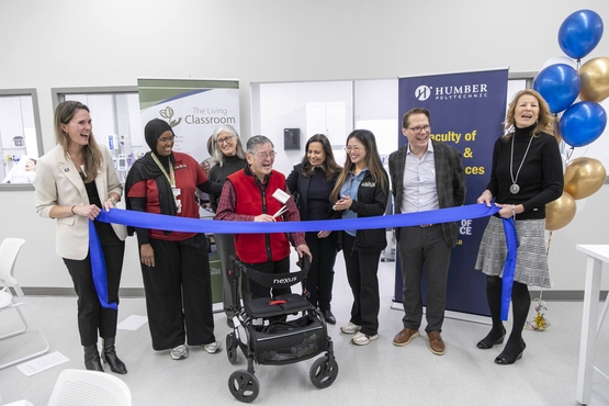 A Humber Heights resident shares laughter with Village team members, Schlegel Villages president and CEO Jamie Schlegel and representatives from Humber Polytechnic during a Ribbon Cutting Ceremony.