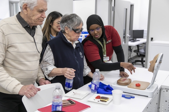 A Humber Heights team member and two residents explore features of the new Living Classroom, opened in partnership with Humber Polytechnic. 