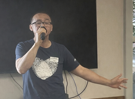 Edgardo sings into the Karaoke microphone.