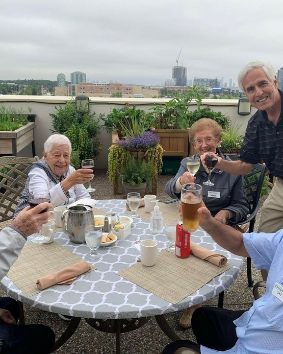 Neighbours offer a toast around the table during a patio party at The Village of Erin Meadows. 