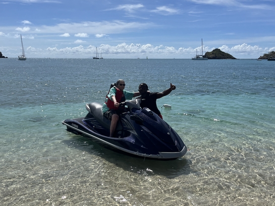 A resident from Tansley Woods sits upon a Sea-Doo in the Caribbean Sea. 