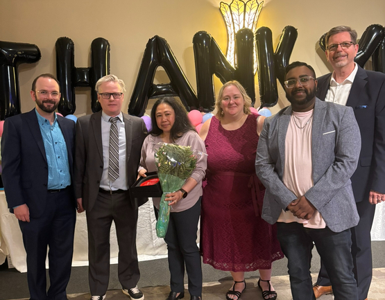 Candy is surrounded by Winston Park Leadership Team Members after she received a 2025 Success Award.