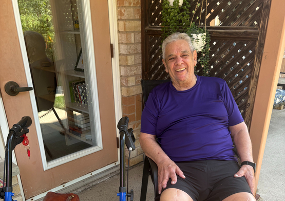 Chuck Marino sits upon his patio with a wide smile upon face. 