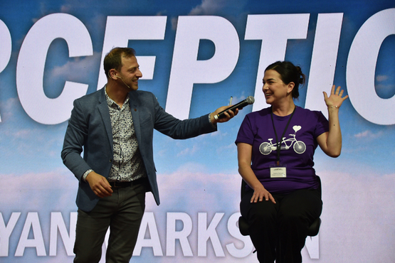 Mentalist Yan Markson engages with a team member on stage during his keynote address at the Operational Planning Retreat. 