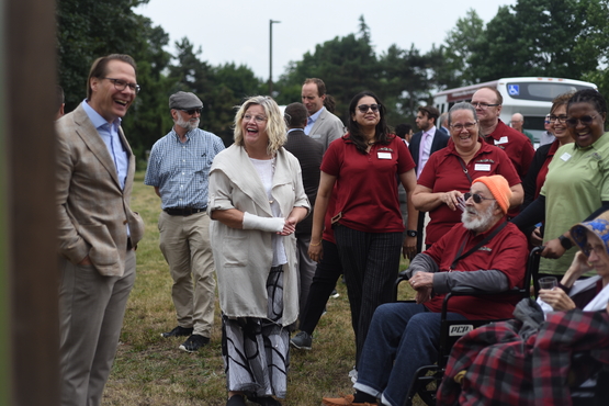Jamie Schlegel and Hamilton Mayor Andrea Horwath share a laugh with residents and team members from Hamilton Continuing Care during the July 31 announcement of the new Village of Fennell Ridge.e