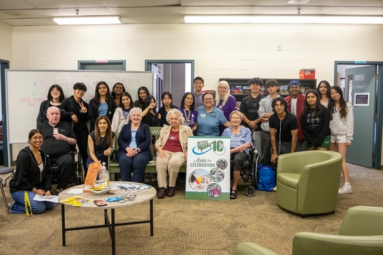 Student gather alongside their four guests from The Village of Erin Meadows for a group photo. 