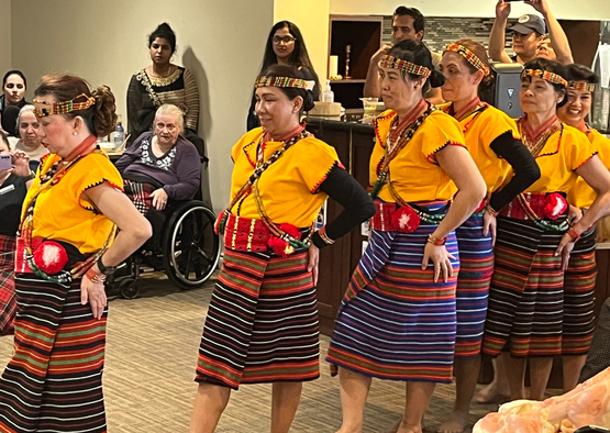 Team members in traditional costume demonstrate a traditional dance from their homeland. 