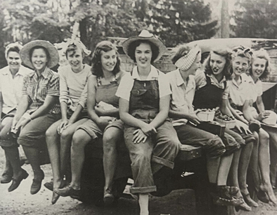 A group of the young ladies who came to be known at the farmerettes sit upon a wagon at some time during the mid-late 1940s.