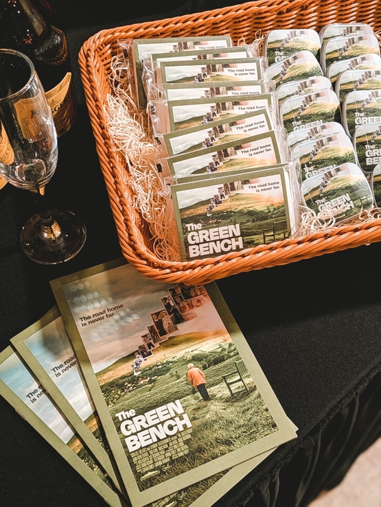 The Green Bench film brochure is displayed alongside other promotional material at the Maycroft Manor screening. 