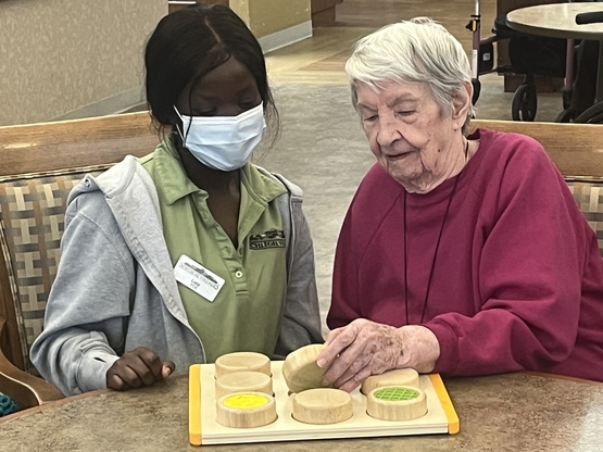 PCA Lucy Okun-Douglas has some one-on-one time with a resident of Riverside Glen's Emma's neighbourhood. 