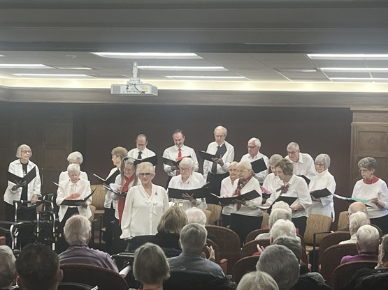 A choir performs in the Town Hall at The Village at University Gates. 