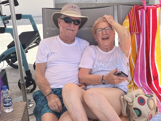 Don and Esme lounge by the pool together during their vacation in Antigua. 