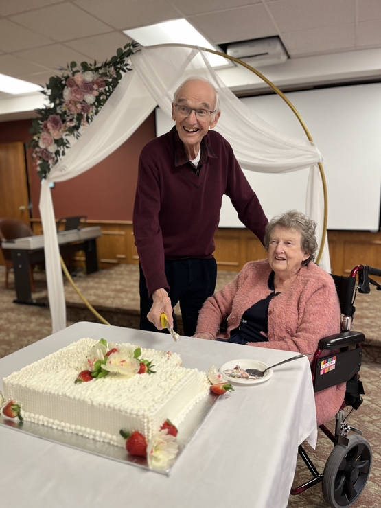 Jim and Marilyn pose as they cut the wedding cake following the vow renewal ceremony at Humber Heights. 