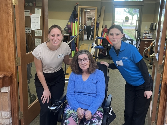Kay is pictured outside of the fitness centre with two team members from the Program for Active Living.