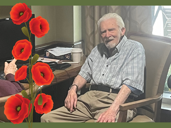 Ken sits in a chair in the library at University Gates, where he shares some of his reflections as a veteran of the Second World War. 