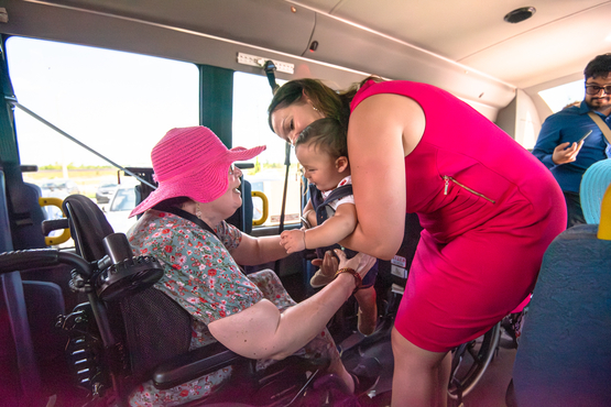 Ontario's LTC minister Natalia Kusendova-Bashta brought her new baby boy aboard the Coleman Care Centre bus following the announcement in Barrie. They are pictured here with a resident. 
