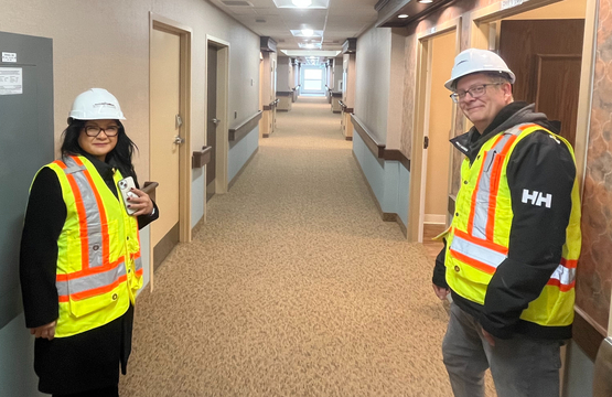 Donna and Peter are pictured in their hardhats and work vests in one of the Ridgeview Court neighbourhoods.