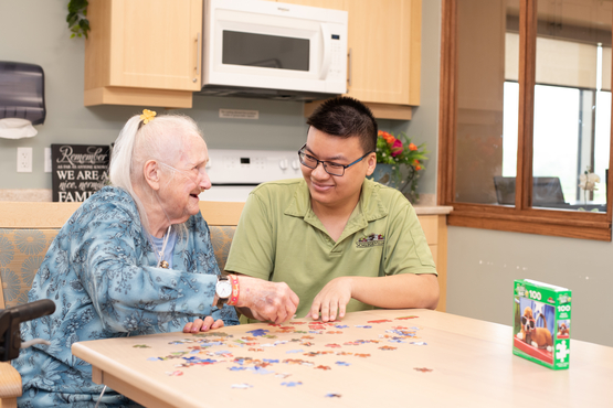 A team member and resident work in a puzzle together in the Country Kitchen off of one of the Village neighbourhoods. As CEO Jamie Schlegel explained at the 2025 Operational Planning Retreat, the neighbourhoods are where the Villages come to life. 