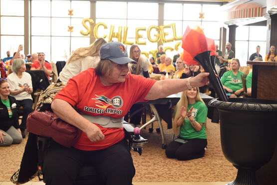 Brenda sets the Olympic torch at the opening ceremonies of the Schlegel Olympics. 