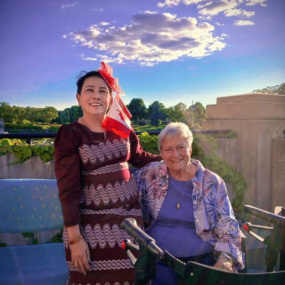Soe stands with a resident from Arbour Trails on Canada Day - she has the red and white Canadian Flag in her hair. 