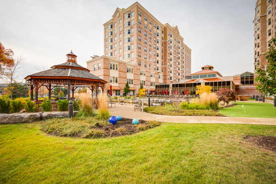An exterior picture of the Village of Tansley Woods with the gazebo in the fore and the retirement suites in the rear.