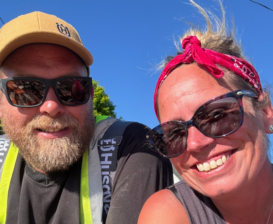Tami and Benn are pictured smiling together under a blue sky. Their lives would transformed when a propane explosion at their home seriously injured Benn.