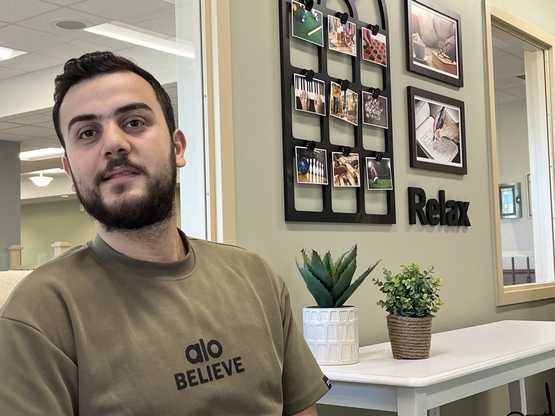 Tawfeeq sits in the lounge in one of the Millers Creek neighbourhoods, talking about the path that led him from Lebanon to Canada. 
