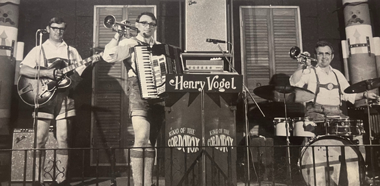 The Henry Vogel Trio band is picture on stage in an old black and white photo. 