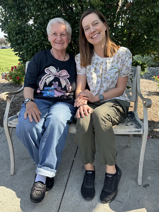Valeriya sits outside alongside one of the many residents from The Village of Aspen Lake she has developed meaningful relationships with over the years.