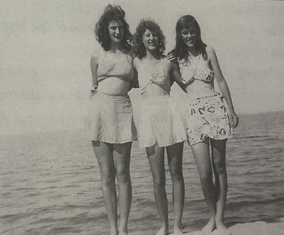Gloria and two friends pose at the beach in the summer of 1946 or 1947.