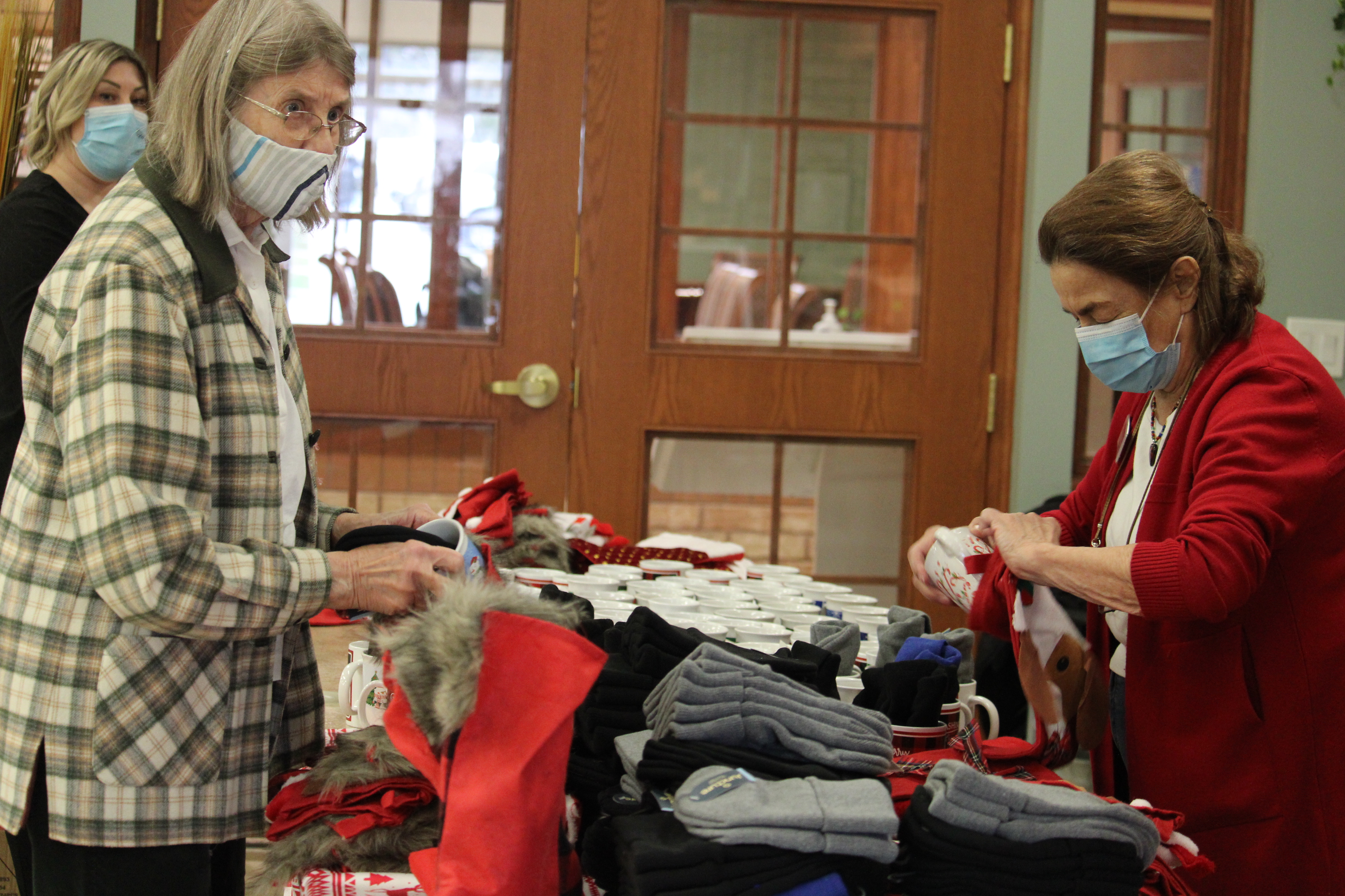 Residents at The Village of Wentworth Heights stuff stockings for those in hospital on Christmas