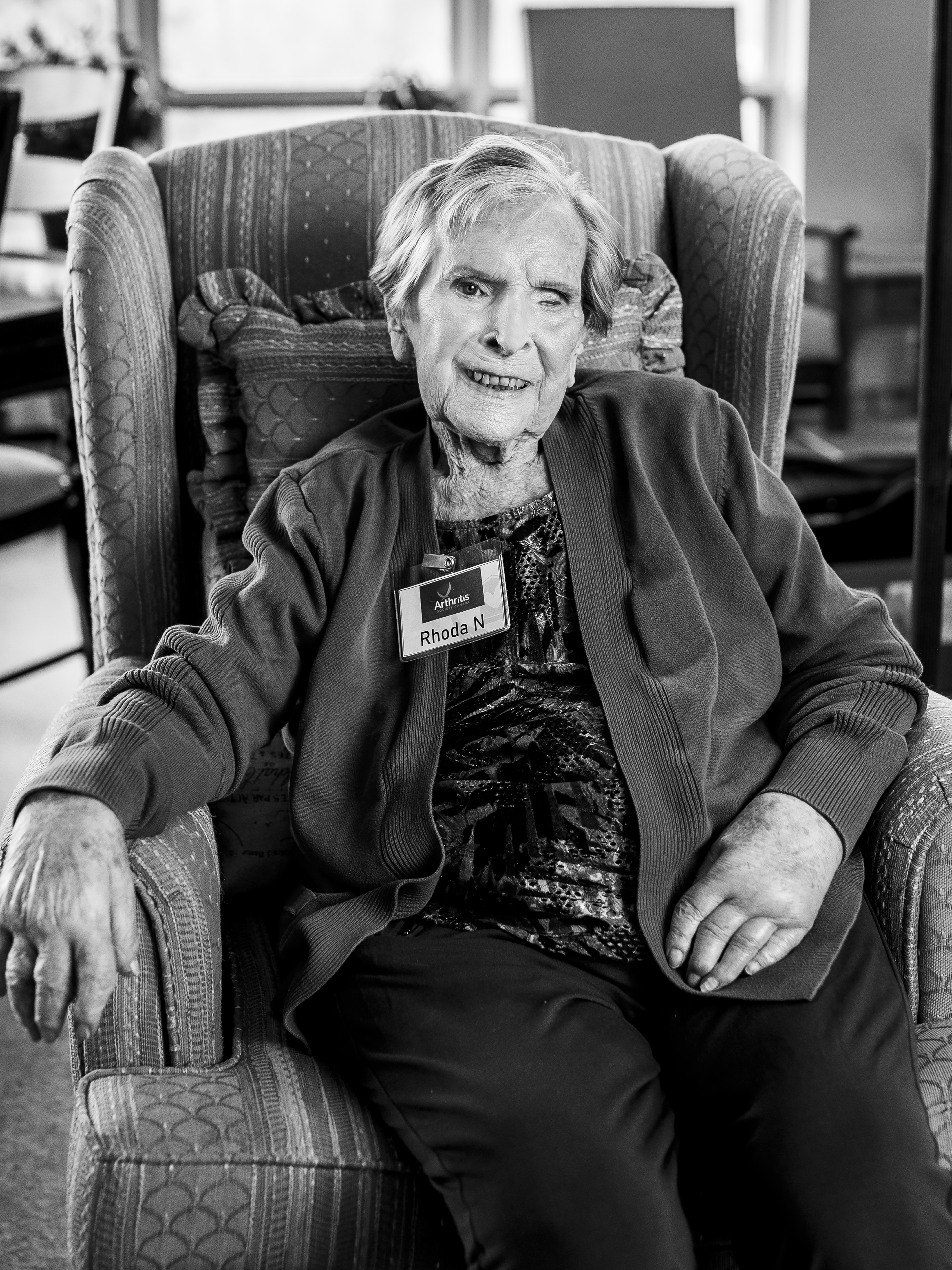 Rhoda black and white portrait wearing a volunteer name tag