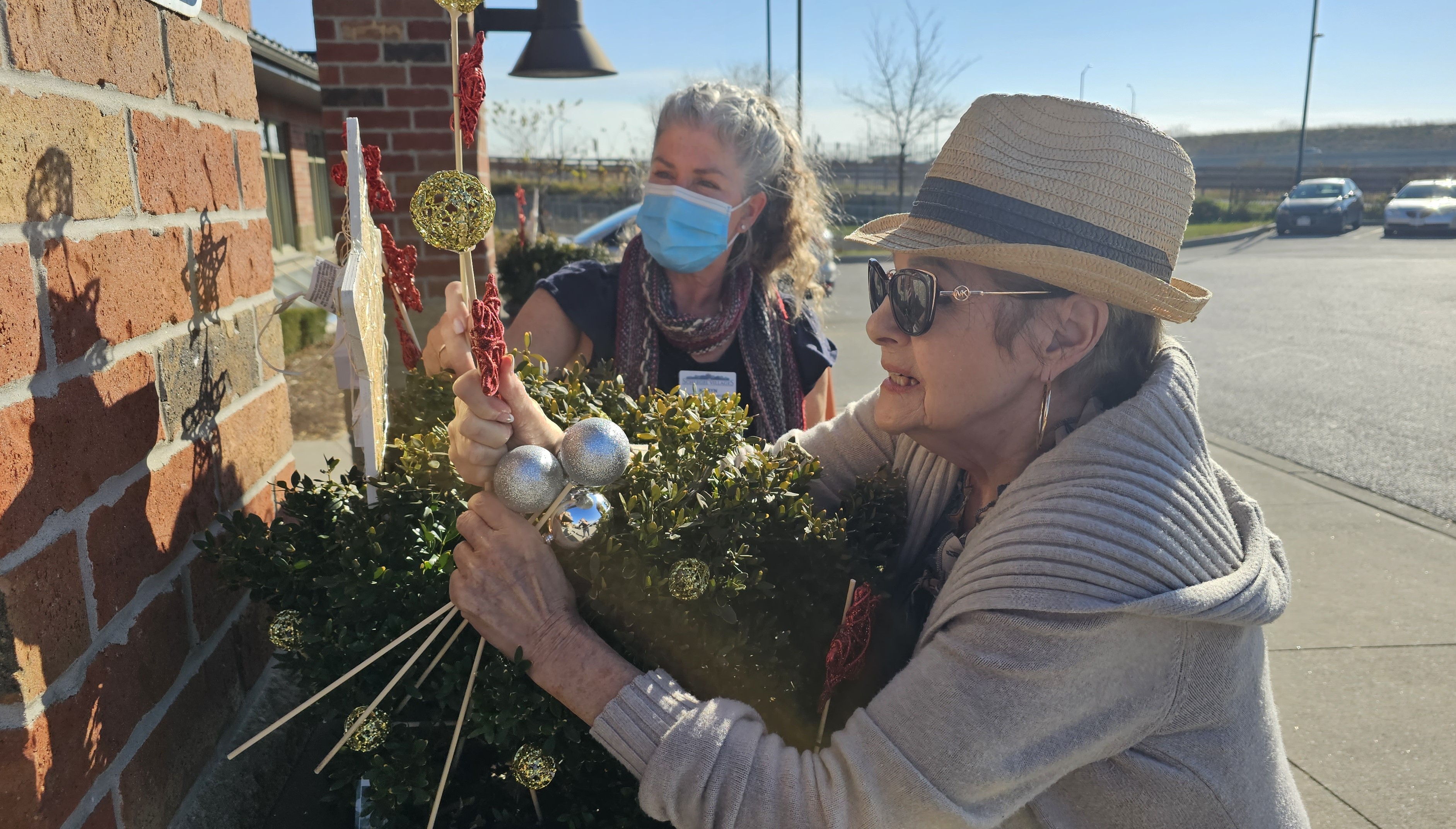 Barb and Karyn decorate the village for the holidays