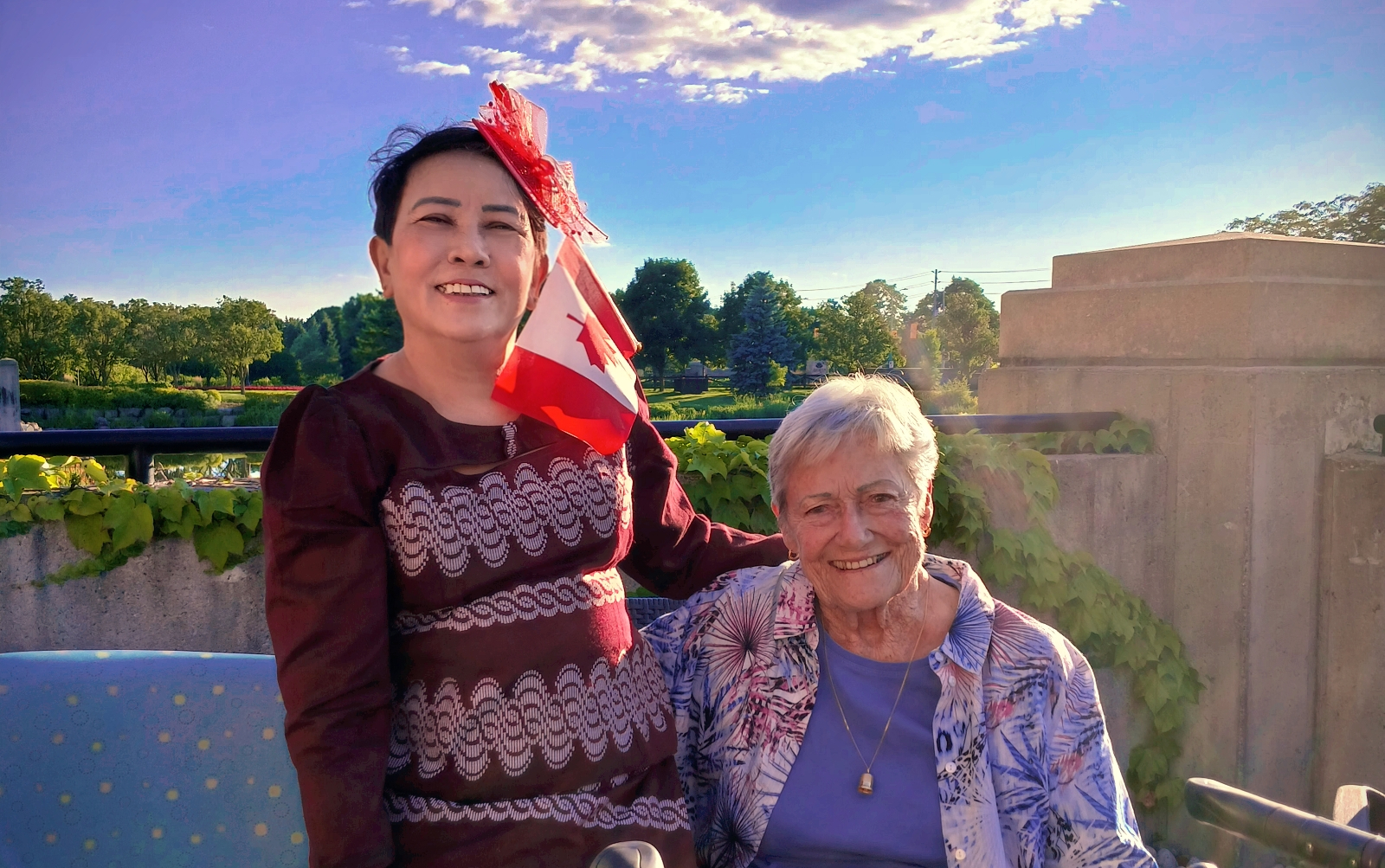 Soe stands with a resident from Arbour Trails on Canada Day - she has the red and white Canadian Flag in her hair. 