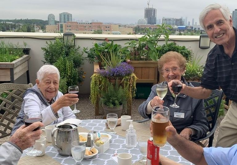 Neighbours offer a toast around the table during a patio party at The Village of Erin Meadows. 