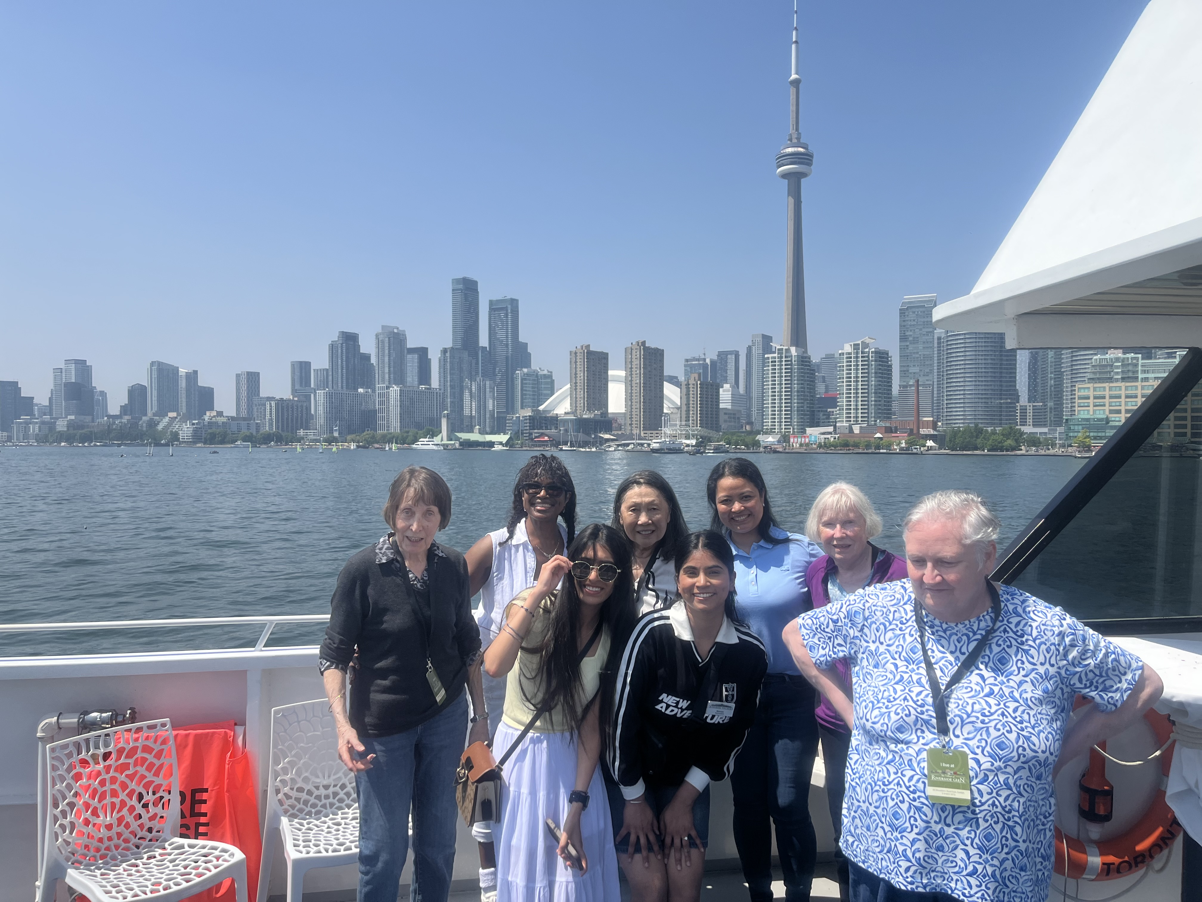 Team members and residents from the Village of Riverside Glen stand at the side of the Yankee Lady IV yacht during the Boat 4 Hope fundraiser with the Toronto skyline in the background. 