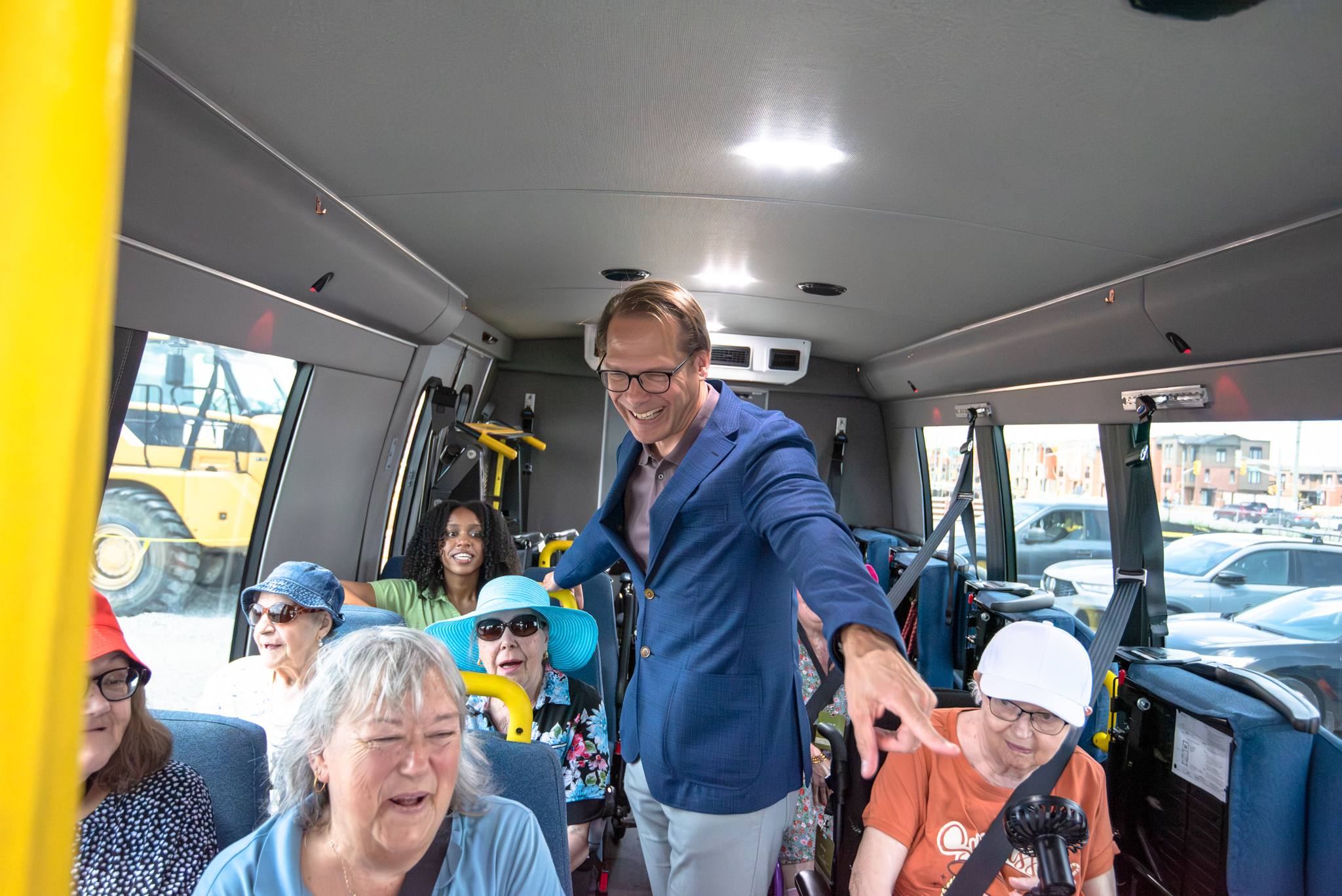 Jamie Schlegel shares a laugh while on the bus with Coleman Care Centre residents. 