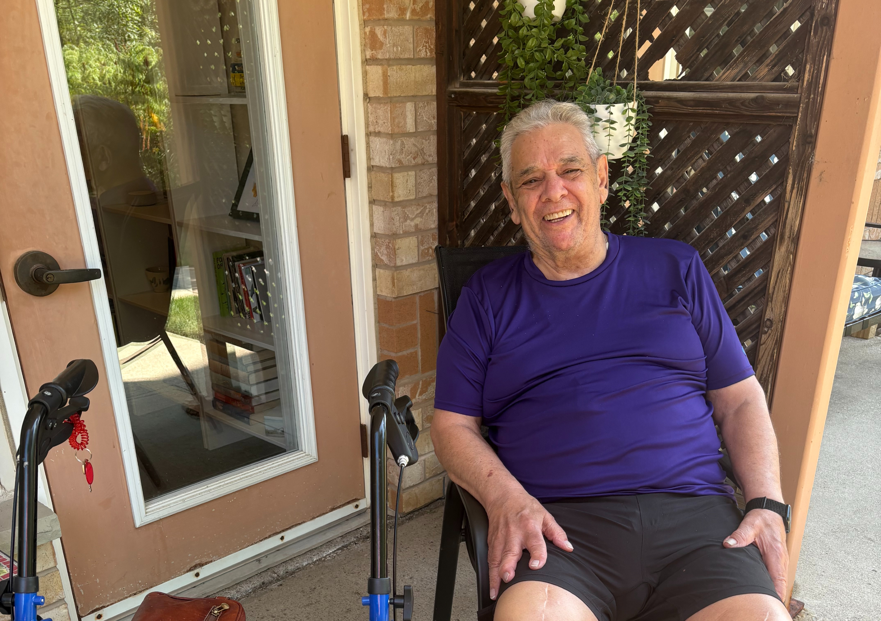 Chuck Marino sits upon his patio with a wide smile upon face. 