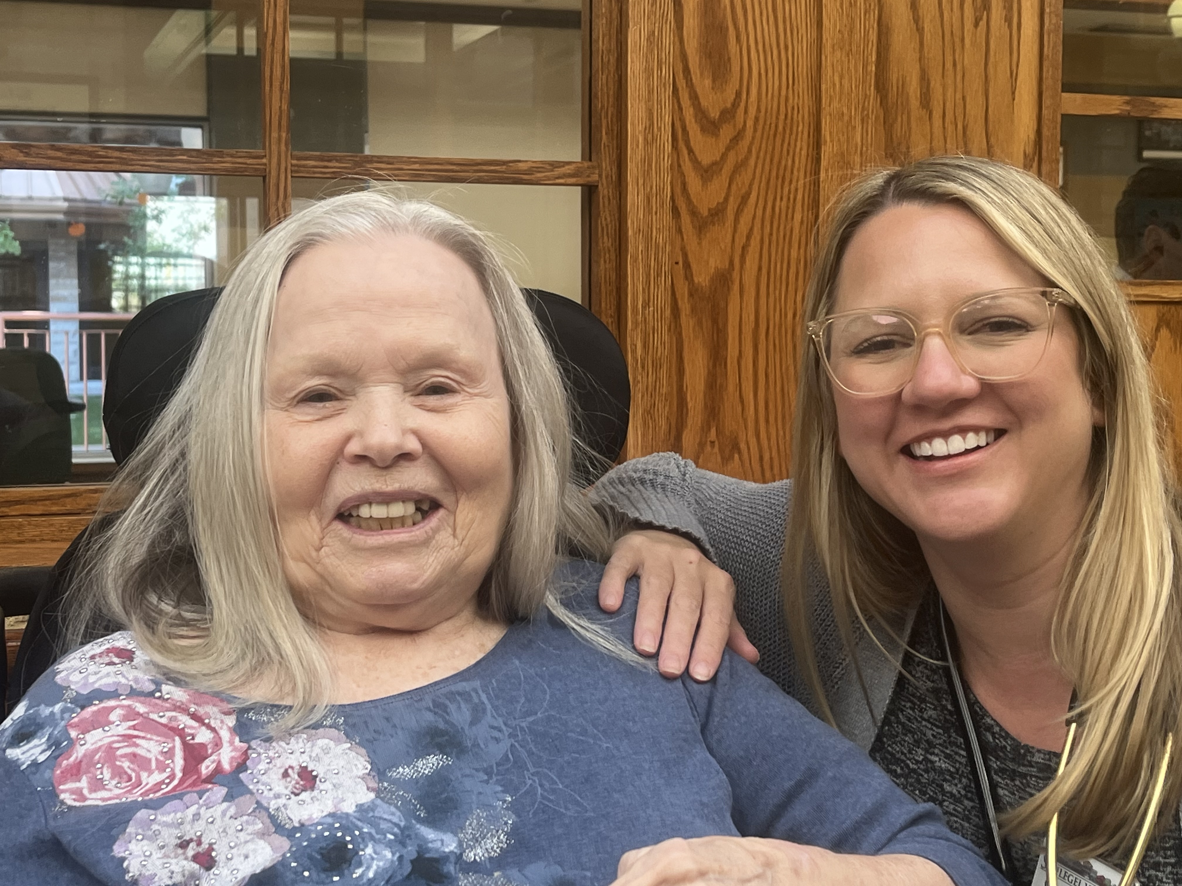 Christine smiles alongside one of the many residents she serves at The Village of Taunton Mills. 