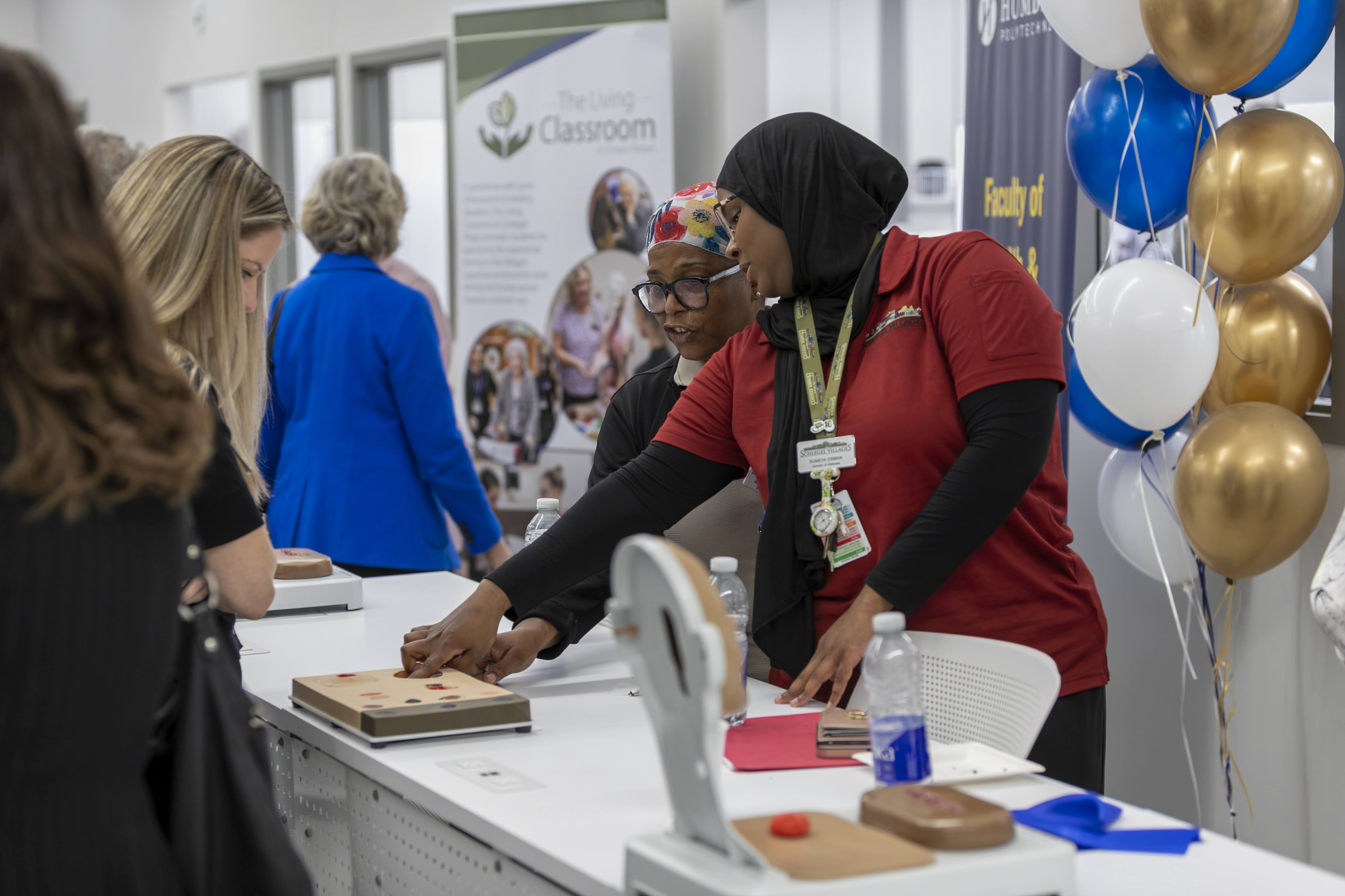 Team members from the Village of Humber Heights explore some of the features in the new Living Classroom that officially opened in the Village. 