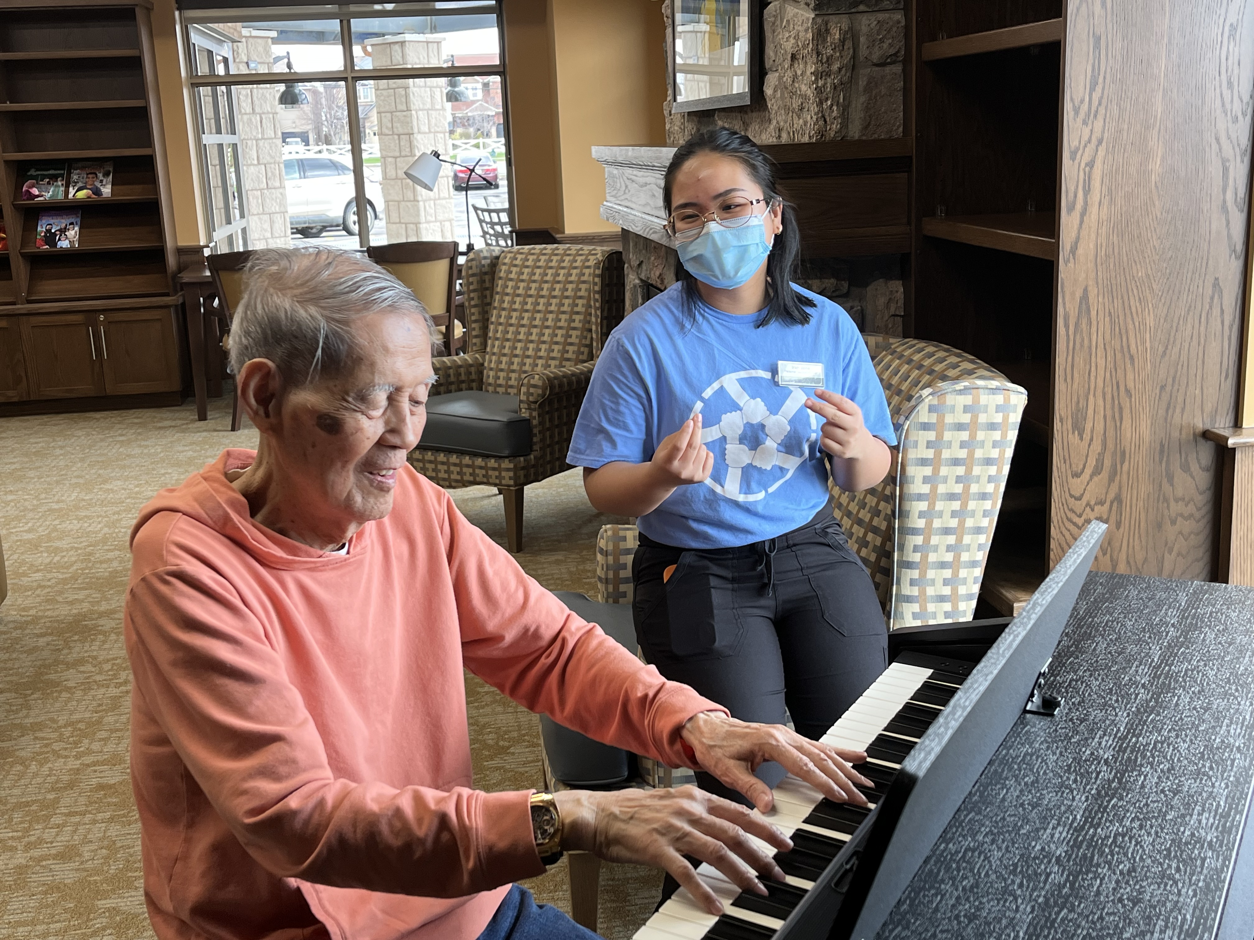 Eusebio plays the piano and sings while Irah Jane sits alongside, snapping her fingers to the tune. 