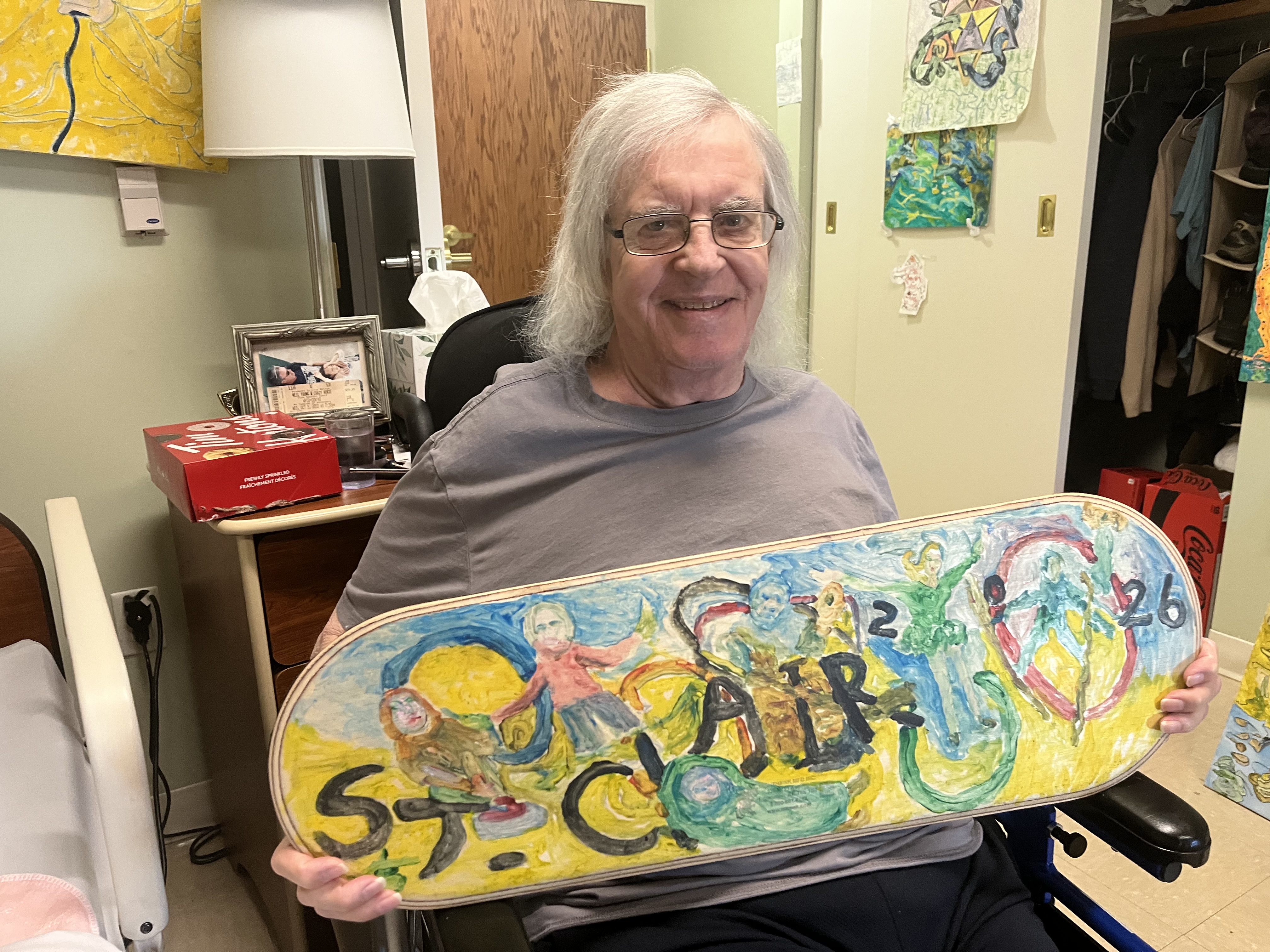 Perry poses with a balance board he painted for the Schlegel Olympics. 