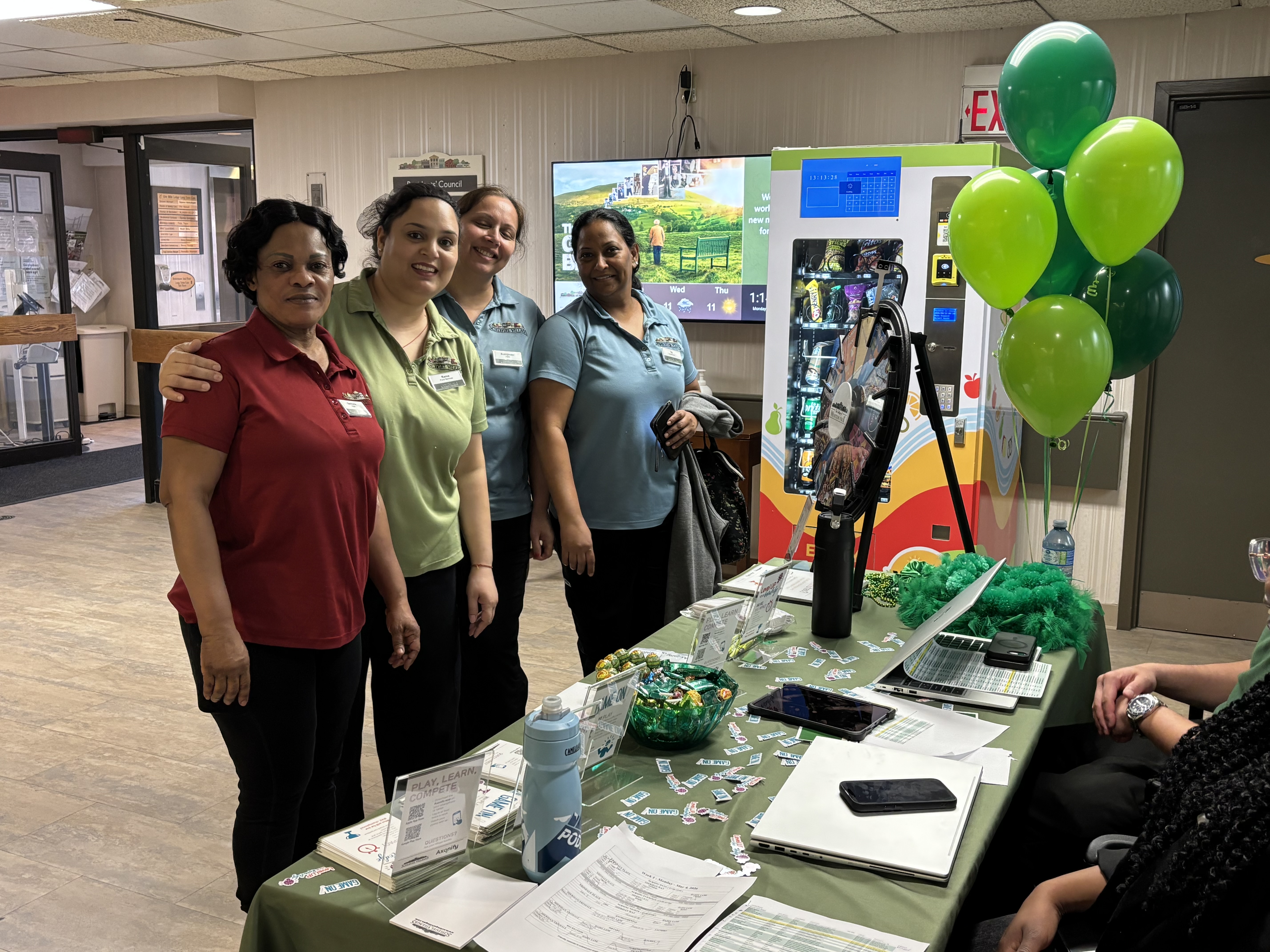 Some fo the team members from Erin Mills Lodge pose during the launch of the Axonify education app at the Village. 