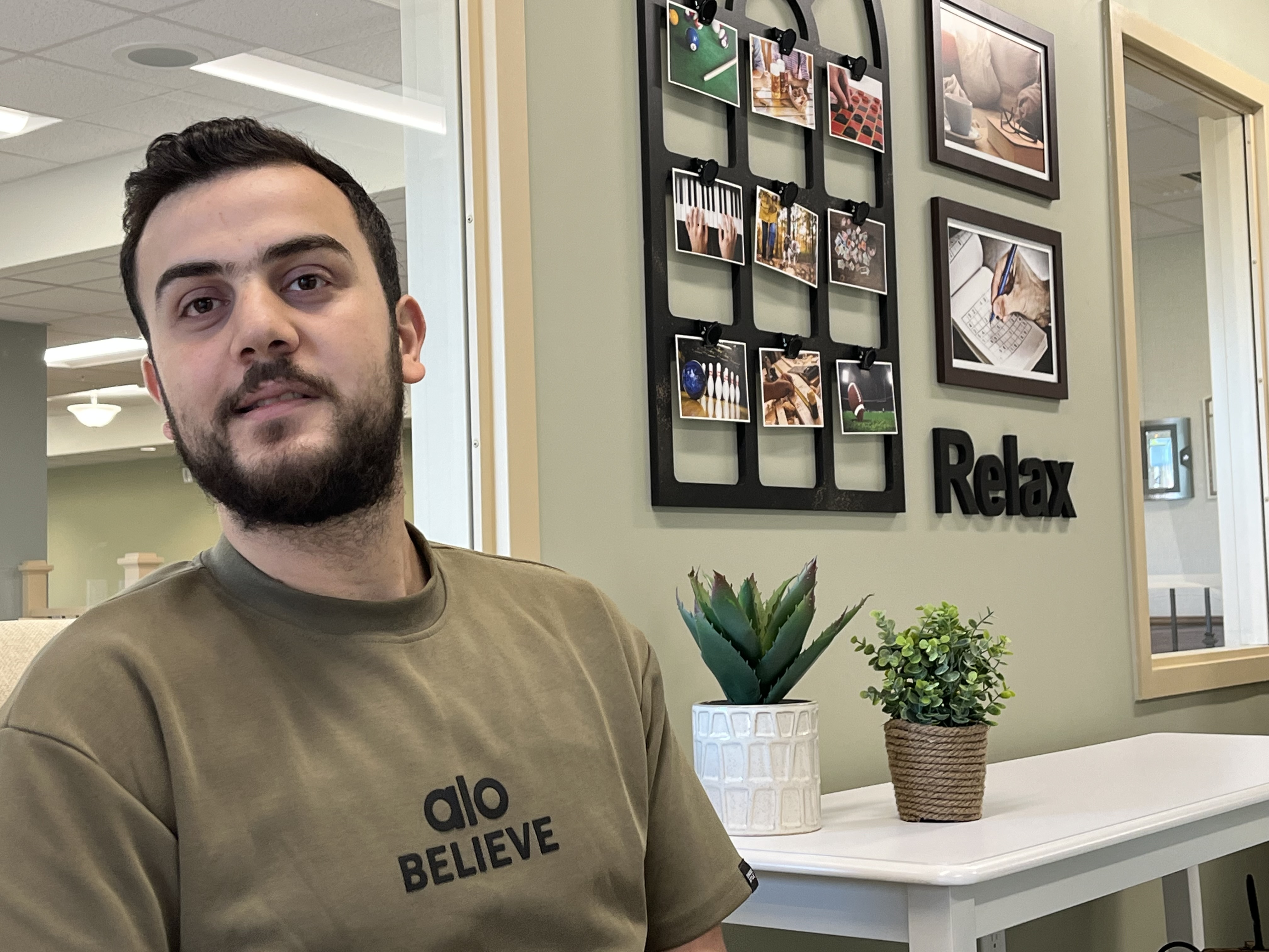 Tawfeeq sits in the lounge in one of the Millers Creek neighbourhoods, talking about the path that led him from Lebanon to Canada. 