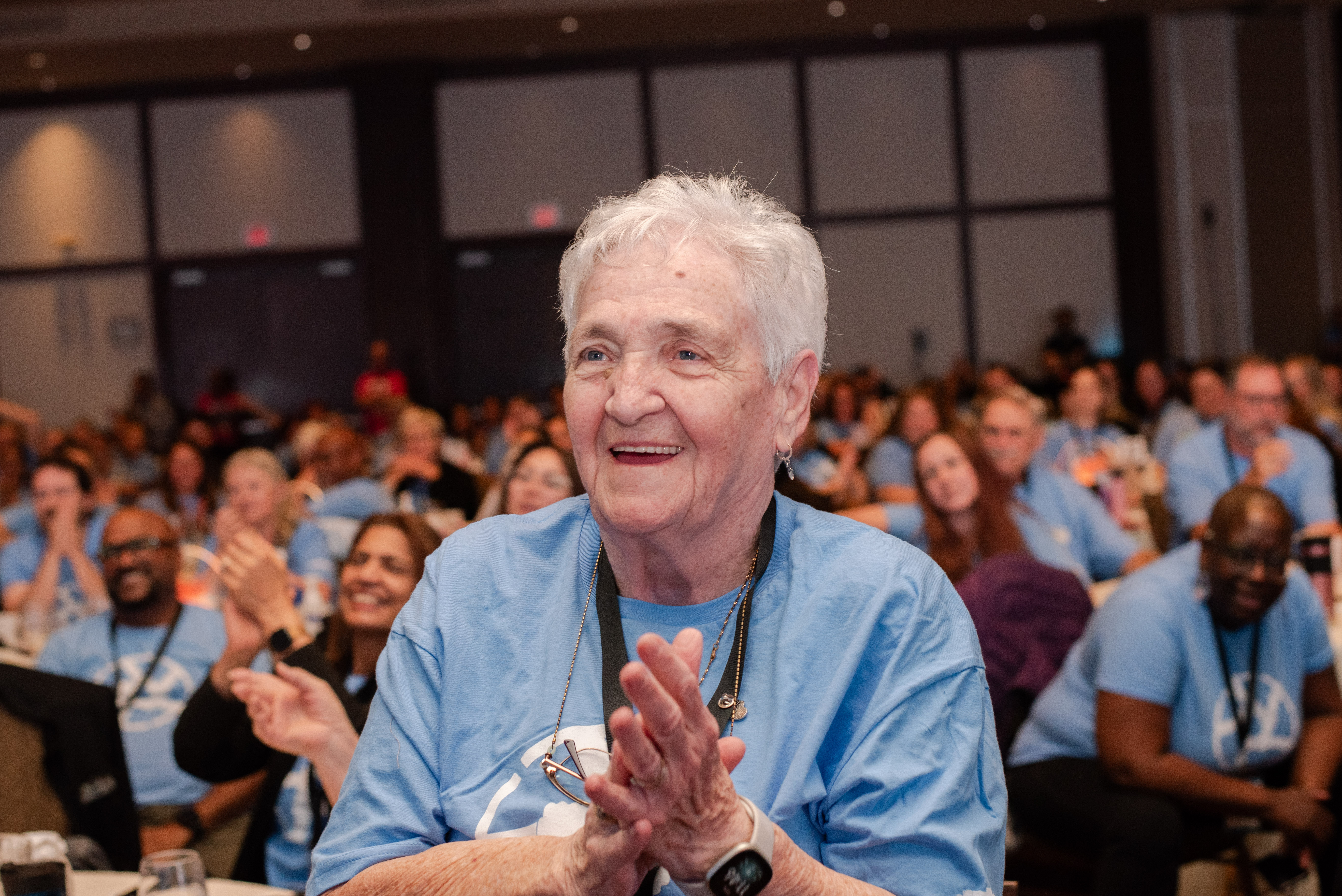 One of several residents to join Schlegel Villages at the annual operational planning retreat smiles as she listens to the keynote address by Jack York.