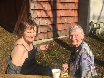 Susan Wilson and Betty Findlay soaking up a bit of sun  during a visit to Camp Schlegel at Shady Pines.