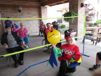 Residents sitting on either side of a volley ball court